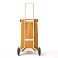 The back view of the Ochre Joyrolla Cart, emphasizing the logo detail on the bag and the strong, sturdy wheels. The wheels, visible from the back, are robust and built to handle various terrains, ensuring smooth and reliable transportation. This Ochre Joyrolla Cart combines style and durability, making it a practical choice for effortless rolling.