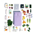 An overhead photo showcasing the lilac bag shows the spacious capacity of the Joyrolla Cart bag, filled with various items. The bag is flatly displayed, and it contains an assortment of fruit and vegetables, a water bottle, and a laptop. The photo highlights the bag's large capacity, demonstrating its ability to accommodate a wide range of items, from groceries to personal belongings. 